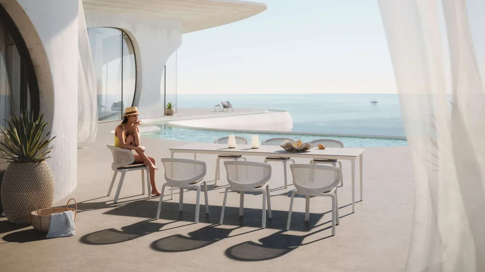 Dedon Seashell Nuo armchair in Pearl, woven patio chairs at an outdoor table